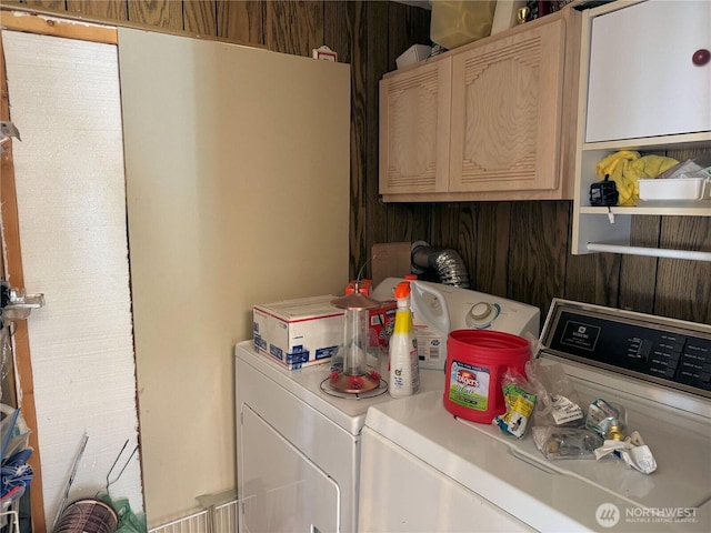 laundry area featuring separate washer and dryer and cabinet space