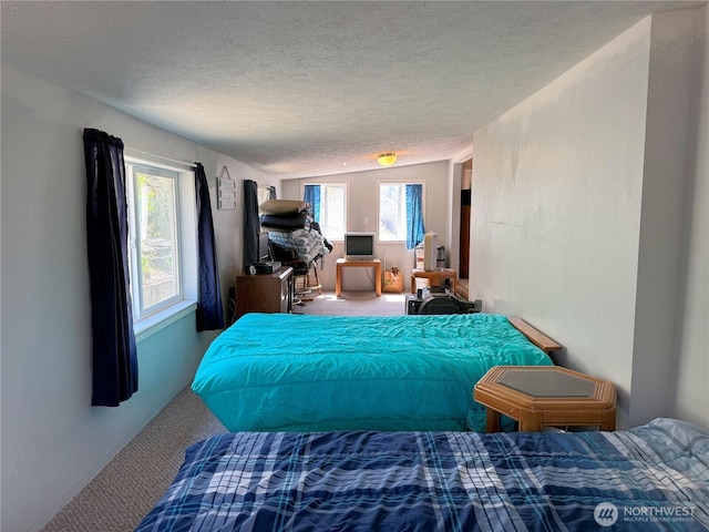 bedroom with a textured ceiling, carpet flooring, and vaulted ceiling