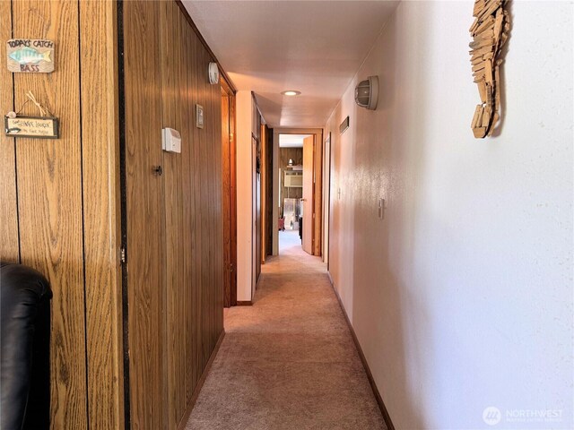 hall featuring light colored carpet