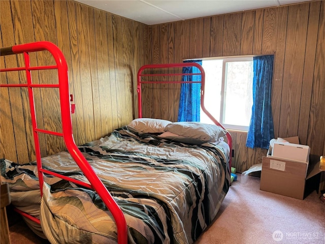 bedroom featuring wood walls and carpet floors