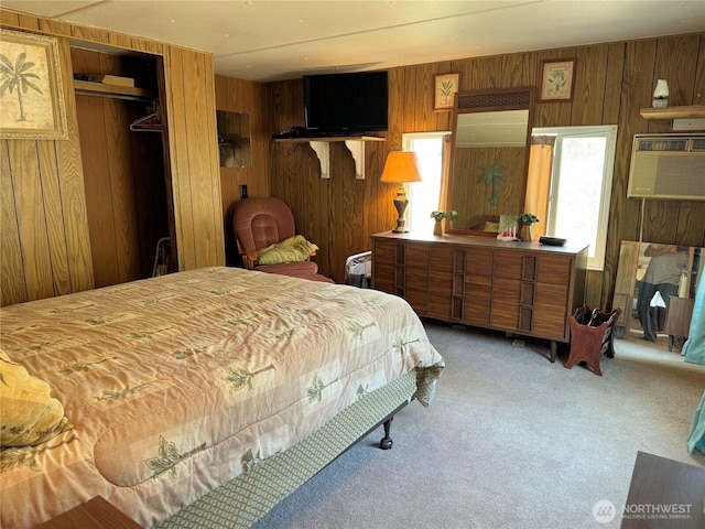 bedroom with wood walls, light colored carpet, and a wall mounted AC