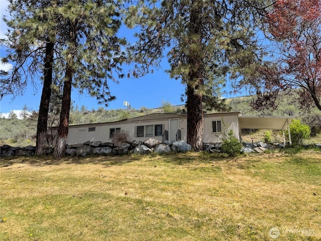 back of property featuring a yard