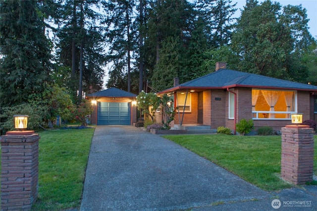 view of front of property featuring brick siding, a front yard, a chimney, concrete driveway, and an outdoor structure