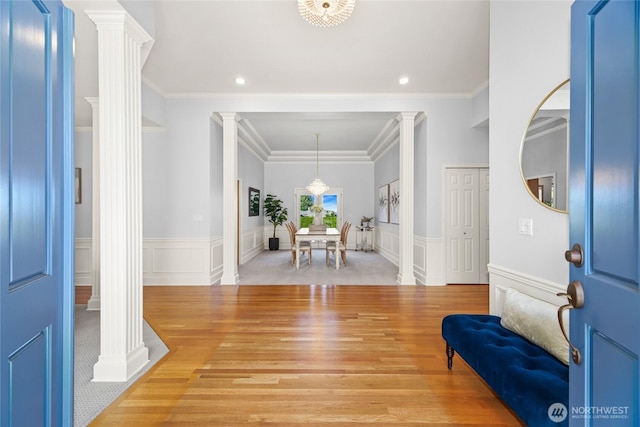 entrance foyer with recessed lighting, wainscoting, ornate columns, and light wood-style flooring