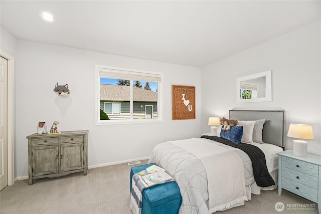 bedroom with baseboards, visible vents, and carpet