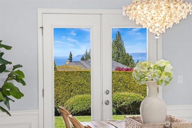 doorway to outside with a chandelier