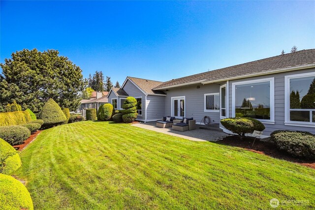 rear view of house featuring a patio, outdoor lounge area, and a yard