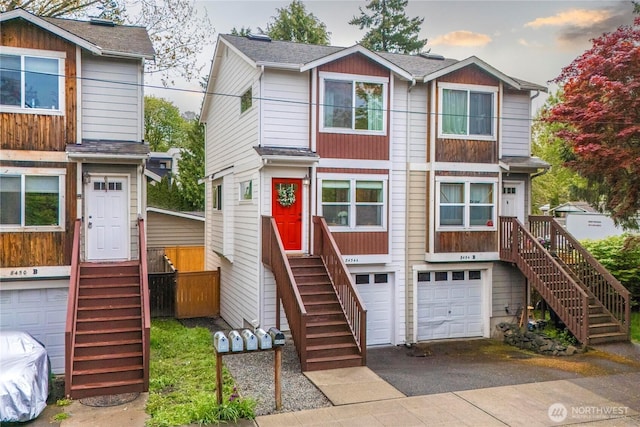 view of front facade with stairs, a garage, driveway, and entry steps