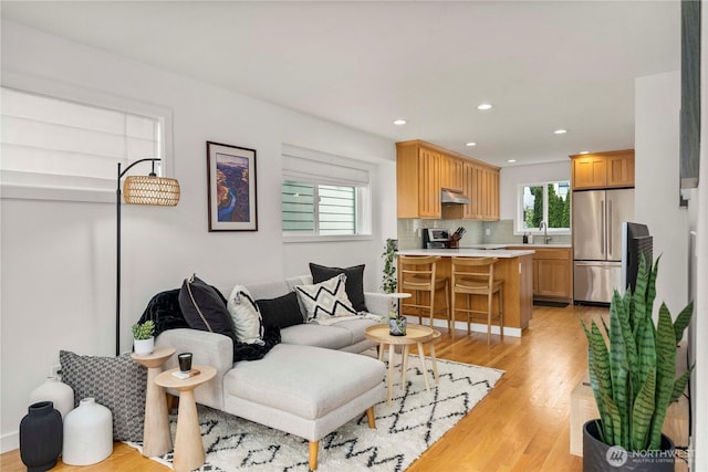 living area featuring recessed lighting and light wood-style flooring