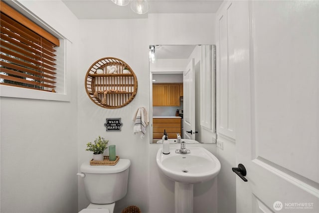 half bathroom with a sink and toilet
