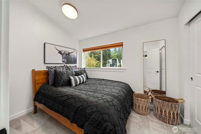 bedroom featuring baseboards, carpet flooring, and lofted ceiling