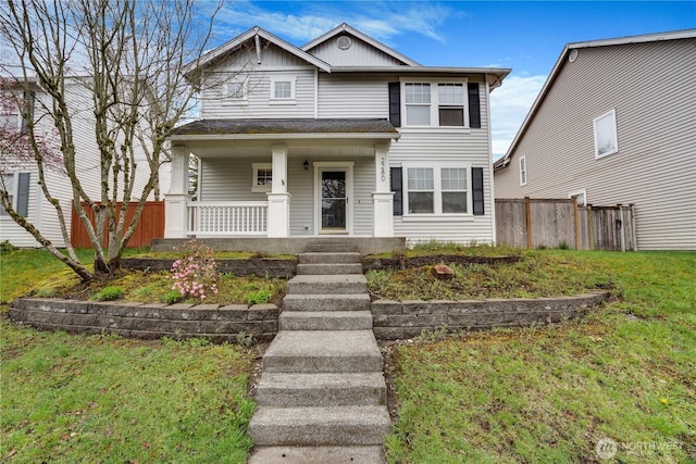 traditional-style home with a porch, board and batten siding, and fence