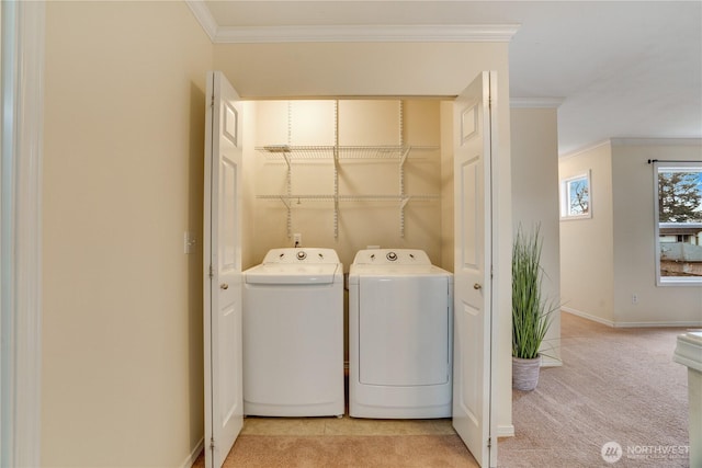 washroom featuring ornamental molding, carpet flooring, laundry area, and washer and clothes dryer