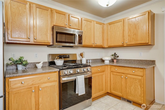 kitchen featuring light tile patterned floors, ornamental molding, visible vents, and appliances with stainless steel finishes