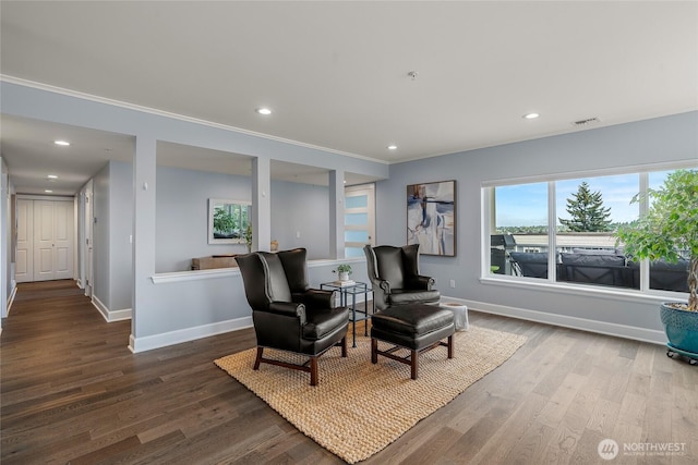 sitting room with baseboards and wood finished floors