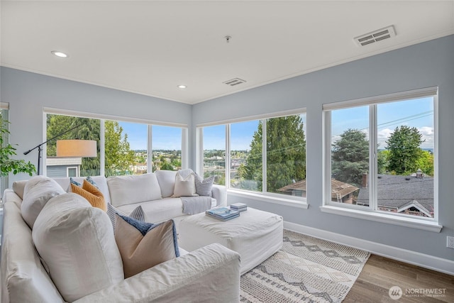 living room with baseboards, plenty of natural light, and visible vents