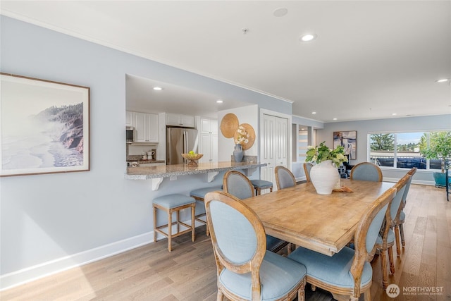 dining space with recessed lighting, baseboards, and light wood-style floors