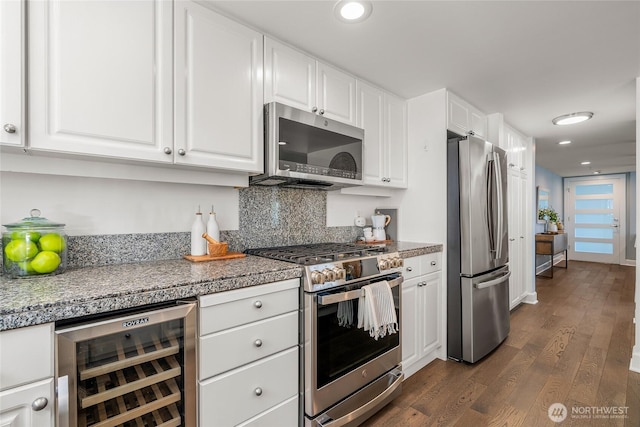 kitchen featuring decorative backsplash, dark wood finished floors, white cabinets, wine cooler, and stainless steel appliances