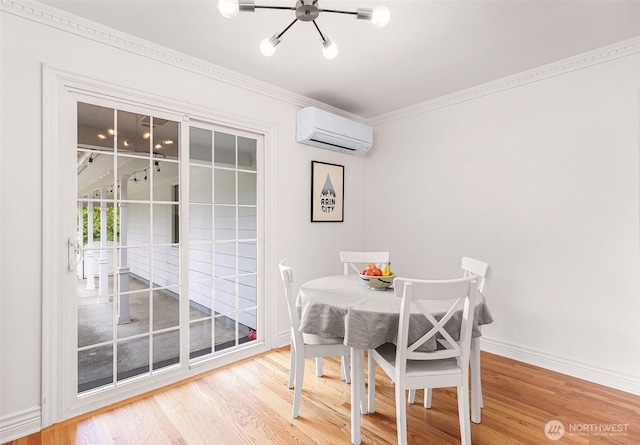 dining space featuring an AC wall unit, baseboards, wood finished floors, and a chandelier
