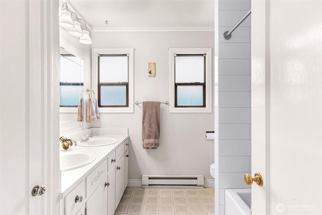 full bathroom featuring double vanity, baseboard heating, a sink, toilet, and ornamental molding