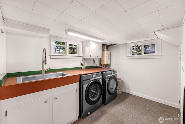 laundry room with washer and dryer, cabinet space, a sink, carpet, and water heater
