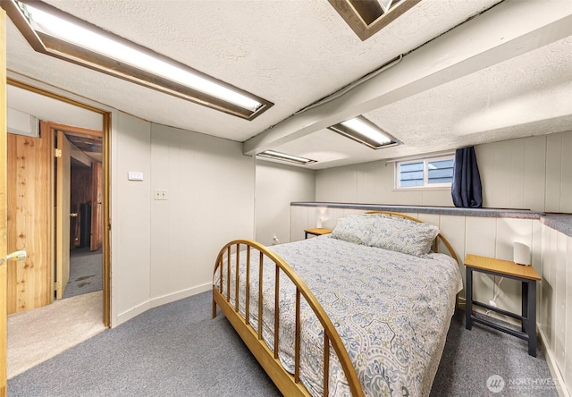 bedroom with carpet floors and a textured ceiling