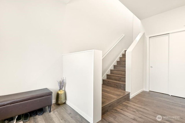 stairway with baseboards and wood finished floors