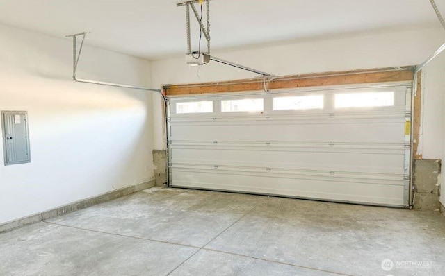 garage with a garage door opener and electric panel