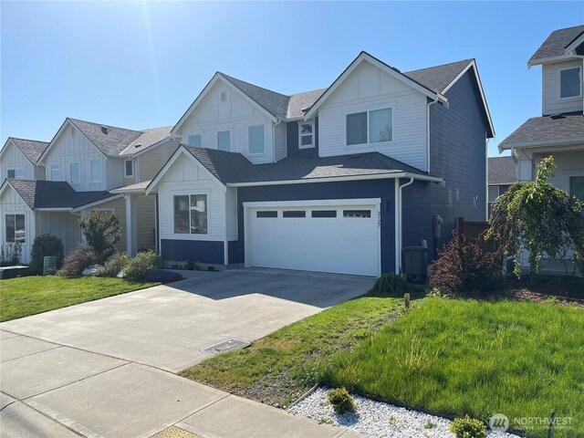 view of front of house featuring board and batten siding, an attached garage, driveway, and a shingled roof
