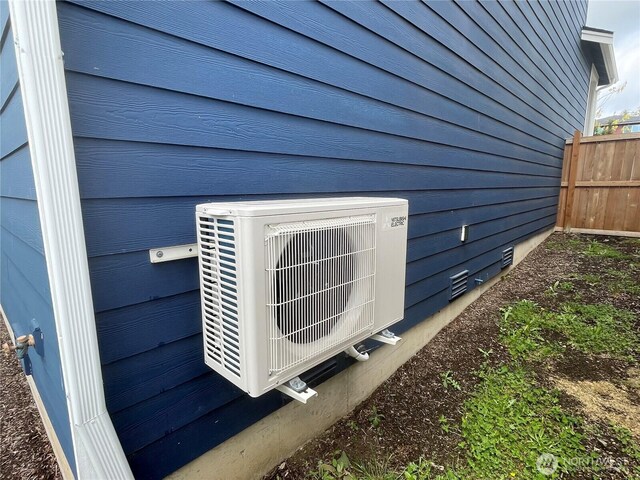 details featuring fence and ac unit