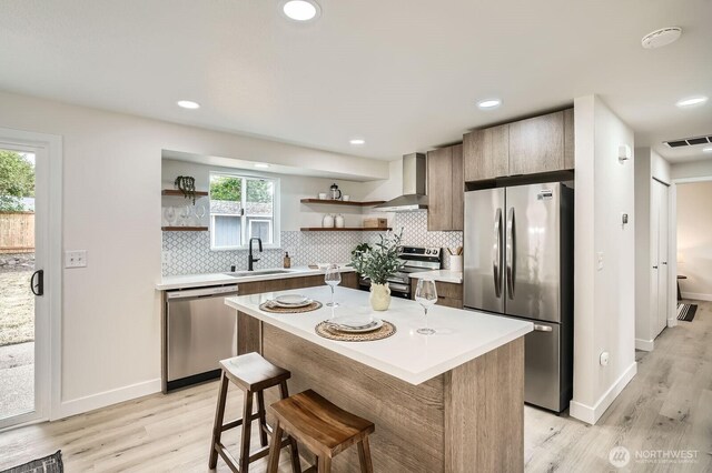 2613 Pike St SE, Auburn, WA 98002 - kitchen with stainless steel appliances, open shelves, wall chimney range hood, a sink, and light countertops