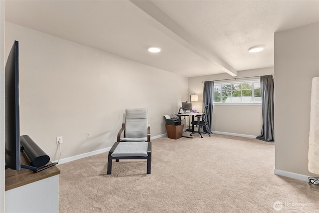 living area featuring carpet, baseboards, beam ceiling, and an office area