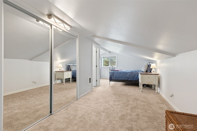 bedroom featuring carpet flooring, lofted ceiling, and baseboards