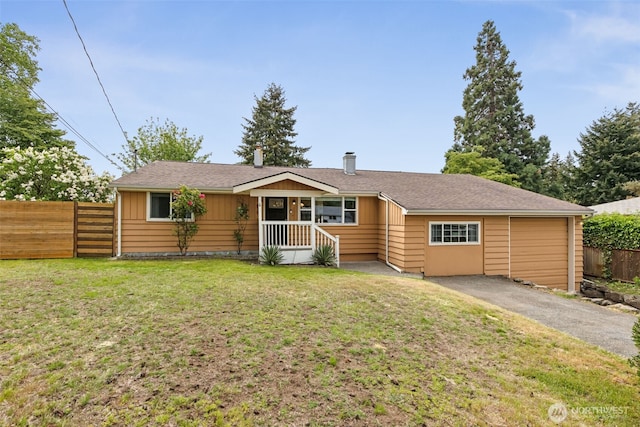ranch-style home with asphalt driveway, a chimney, and a garage