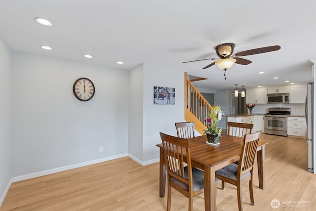 dining room featuring baseboards, light wood-style floors, ceiling fan, and recessed lighting