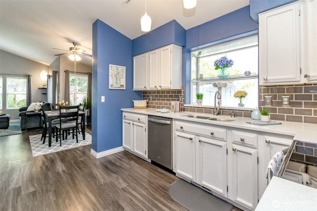 kitchen featuring stainless steel dishwasher, white cabinetry, ceiling fan, and a sink