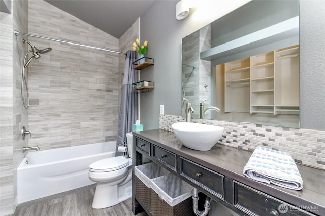 bathroom with vanity, toilet, shower / bath combination with curtain, decorative backsplash, and wood finished floors