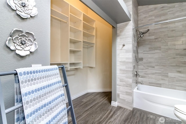 full bathroom with baseboards, shower / bathing tub combination, toilet, and wood finished floors