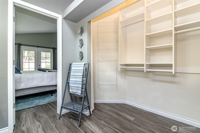walk in closet featuring french doors and dark wood-style floors