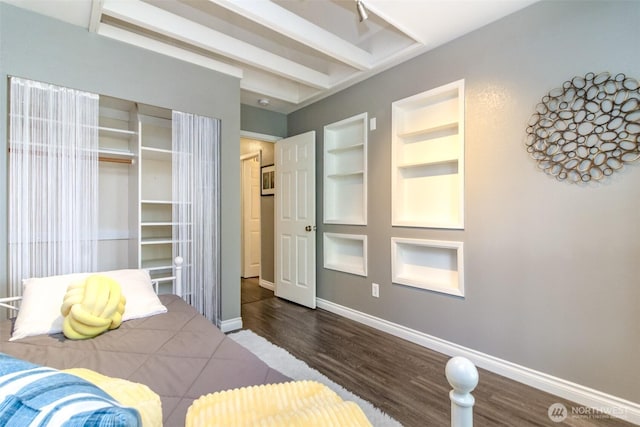 unfurnished bedroom with baseboards and wood finished floors