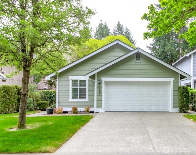 ranch-style home featuring a garage, a front yard, and concrete driveway
