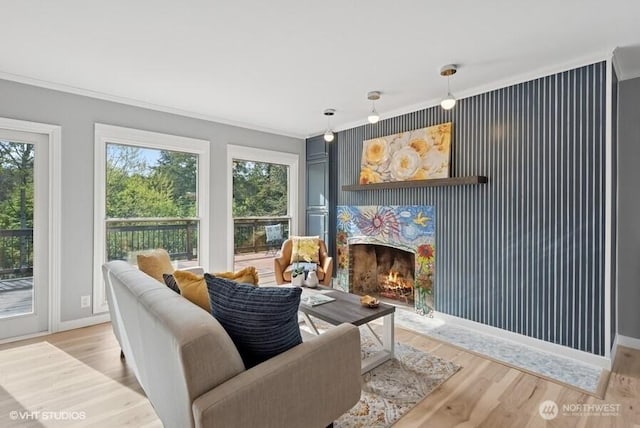 living room with crown molding, a wealth of natural light, and wood finished floors
