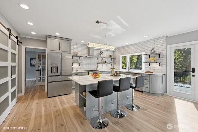 kitchen with open shelves, gray cabinets, backsplash, and stainless steel appliances