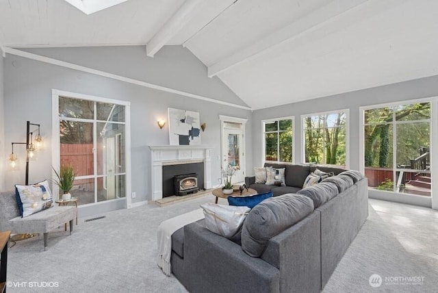 living area featuring vaulted ceiling with skylight, carpet, and visible vents