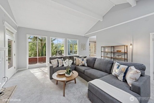 living room with lofted ceiling with beams, baseboards, and light carpet
