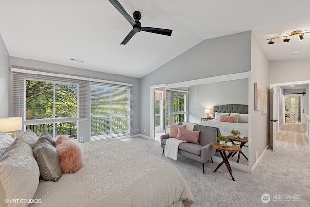 bedroom with baseboards, carpet flooring, vaulted ceiling, and multiple windows
