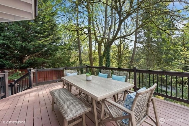 wooden terrace featuring outdoor dining space