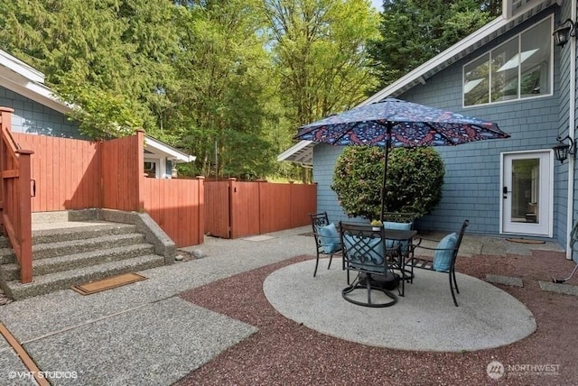 view of patio with fence and outdoor dining area