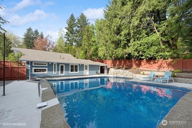 view of swimming pool featuring a fenced in pool, a patio, a diving board, and fence private yard