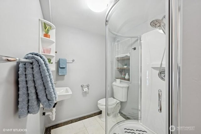 full bath with tile patterned flooring, baseboards, a stall shower, and toilet